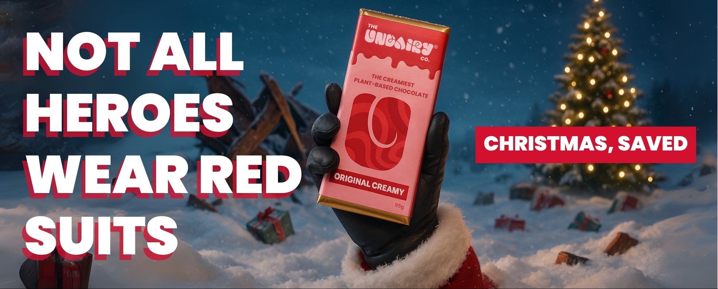 Person holding a box of Original Creamy with Christmas tree and presents in the background