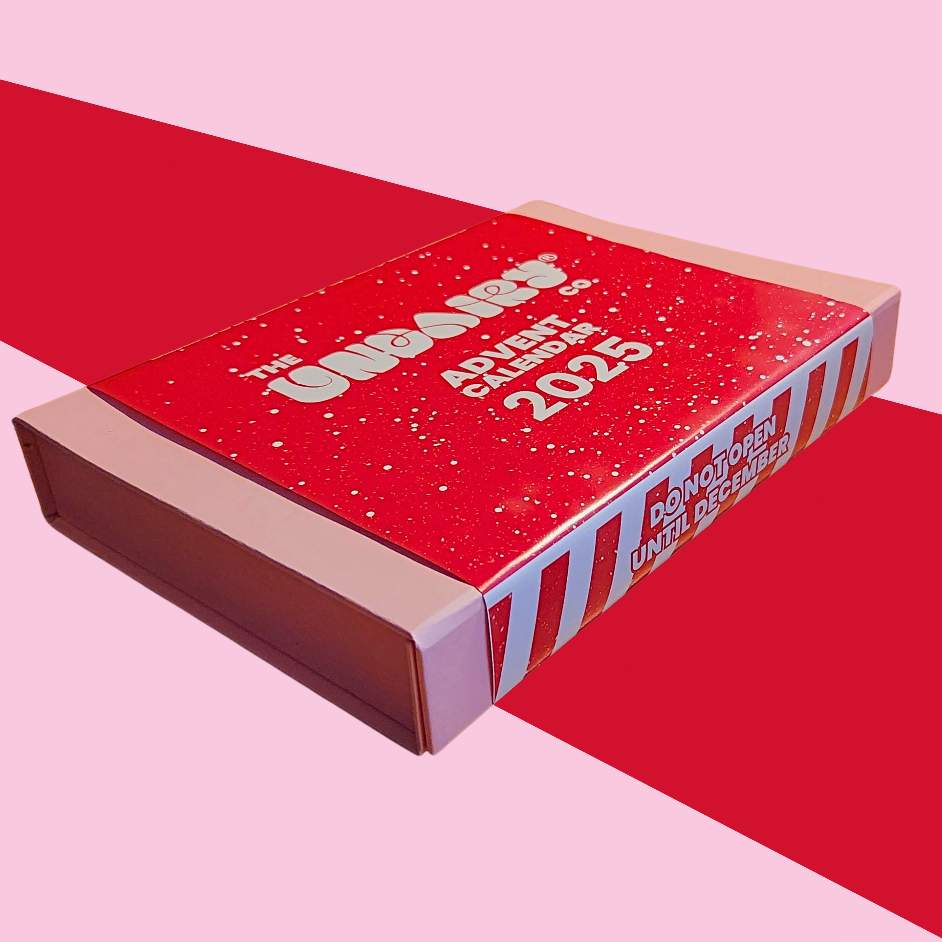 Red advent calendar box with '2025' text on a pink background